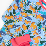 Frugi GOTS 100% organic cotton kids pyjama top in light blue with a repeating shetland pony print and a pink cuff and neck line 