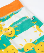 Frugi green and white striped shorts with repeating sunshine design laid flat showing back pocket