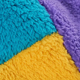Frugi ted fleece trapper hat, close up of soft, recycled polyester fleece in yellow, blue and purple colourblock.