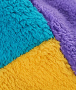Frugi ted fleece trapper hat, close up of soft, recycled polyester fleece in yellow, blue and purple colourblock.