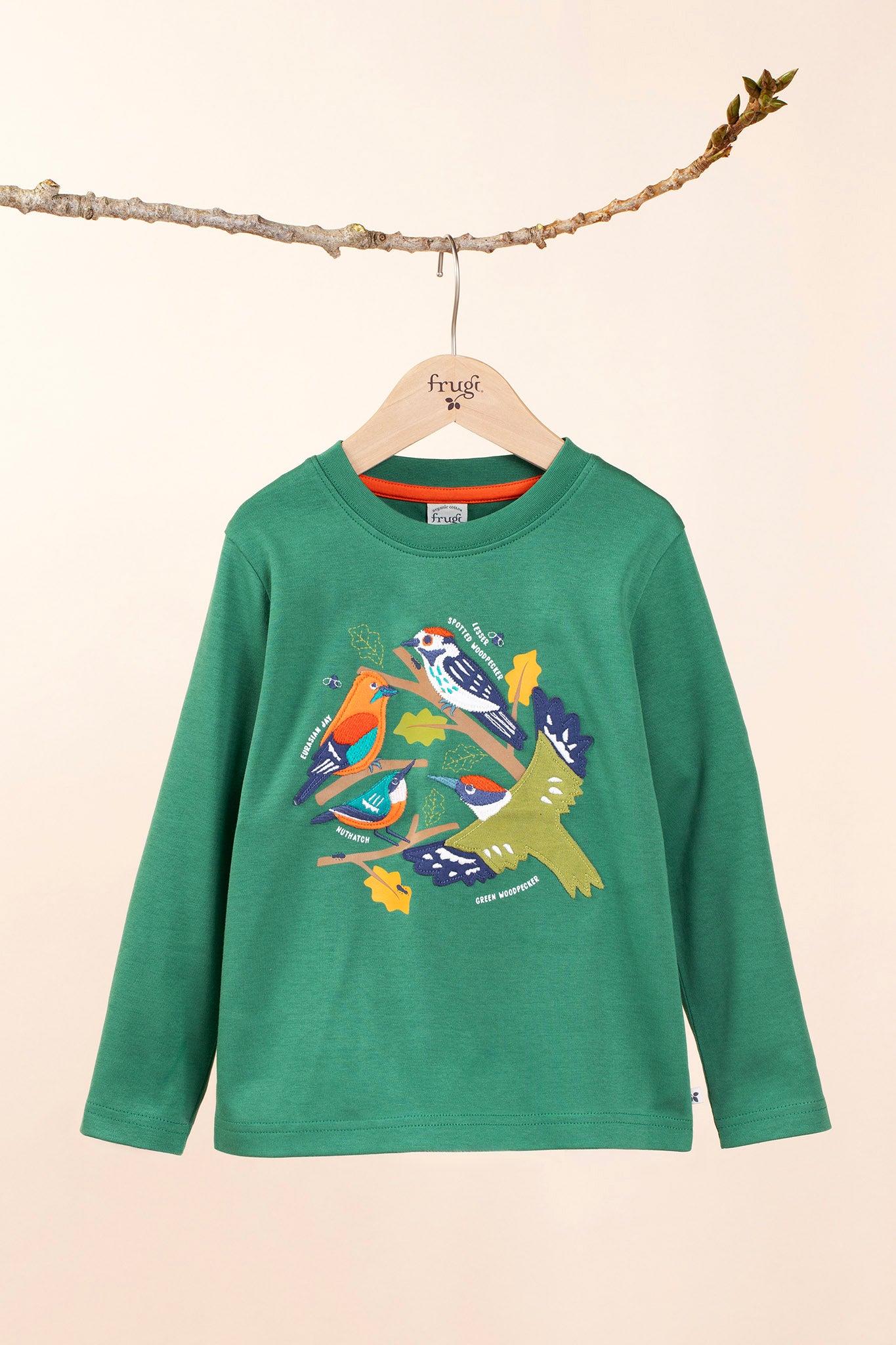 Frugi kids terrific applique top in holly green/birds hanging on a branch and available at Babipur. A GOTS organic long sleeve top in dark green. Features a collection of different bird appliques perched on branches