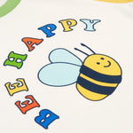 The Bee and Bee Happy logo on the Frugi Tamar Raglan Top - Soft White/Bee Happy
