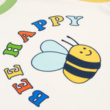 The Bee and Bee Happy logo on the Frugi Tamar Raglan Top - Soft White/Bee Happy