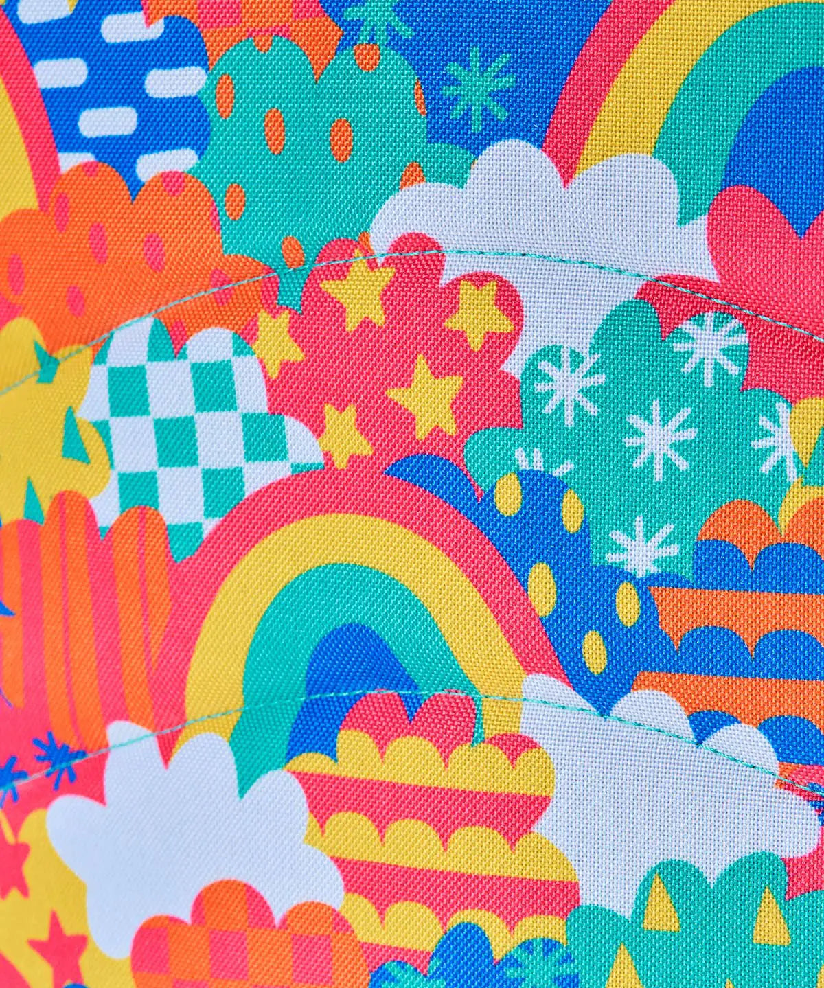 Frugi fun frenzy trail blazing backpack showing a close up of the repeating multicoloured abstract cloud design. 