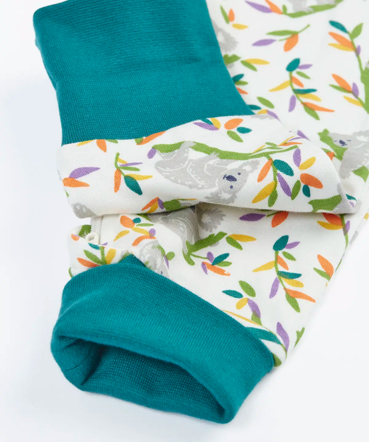 Frugi GOTS 100% organic cotton onesie in white with repeating koala prints showing close up of the teal leg cuffs