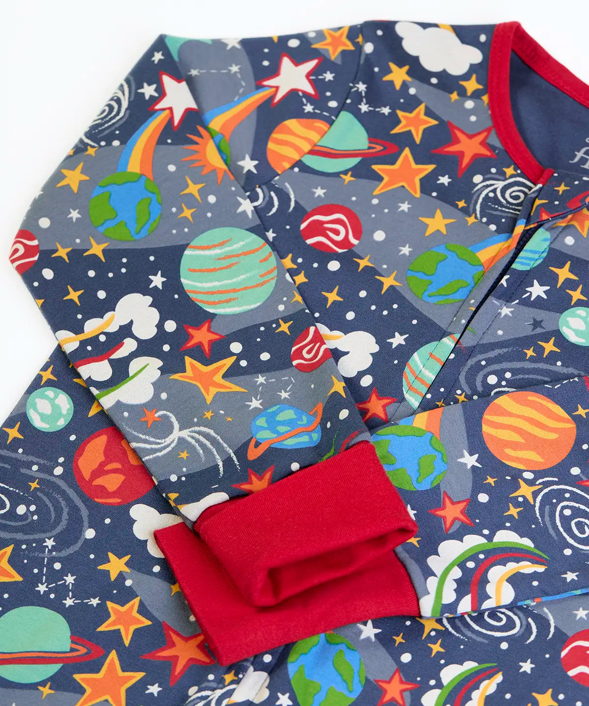 Frugi GOTS 100% organic cotton navy onesie laid flat showing a repeating outer space print, red cuffs and neck trim
