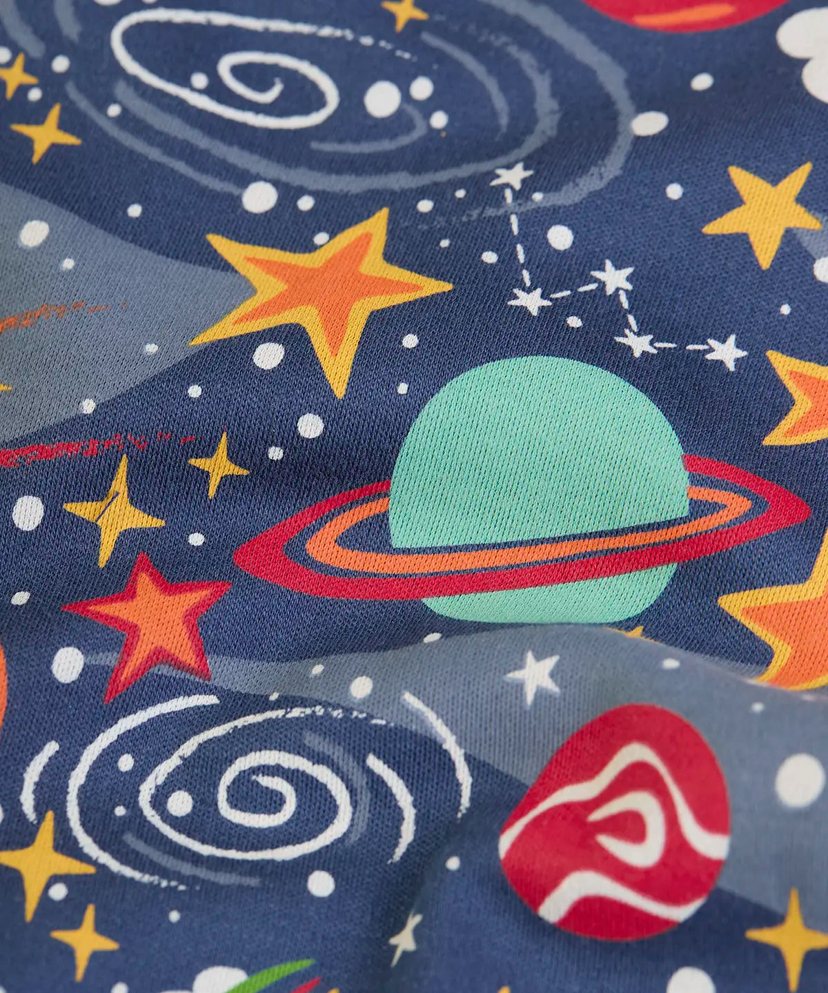 Frugi kids onesie laid flat showing a repeating outer space print on navy organic cotton fabric