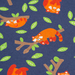 A closer look at the Red Panda Pals print. The image shows a navy blue fabric, with cute sleeping red pandas on their own or sleeping on a tree branch, a long with green leaves