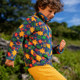 Frugi zipped ted fleece in navy with orange star print worn by child outside with yellow cord trousers.