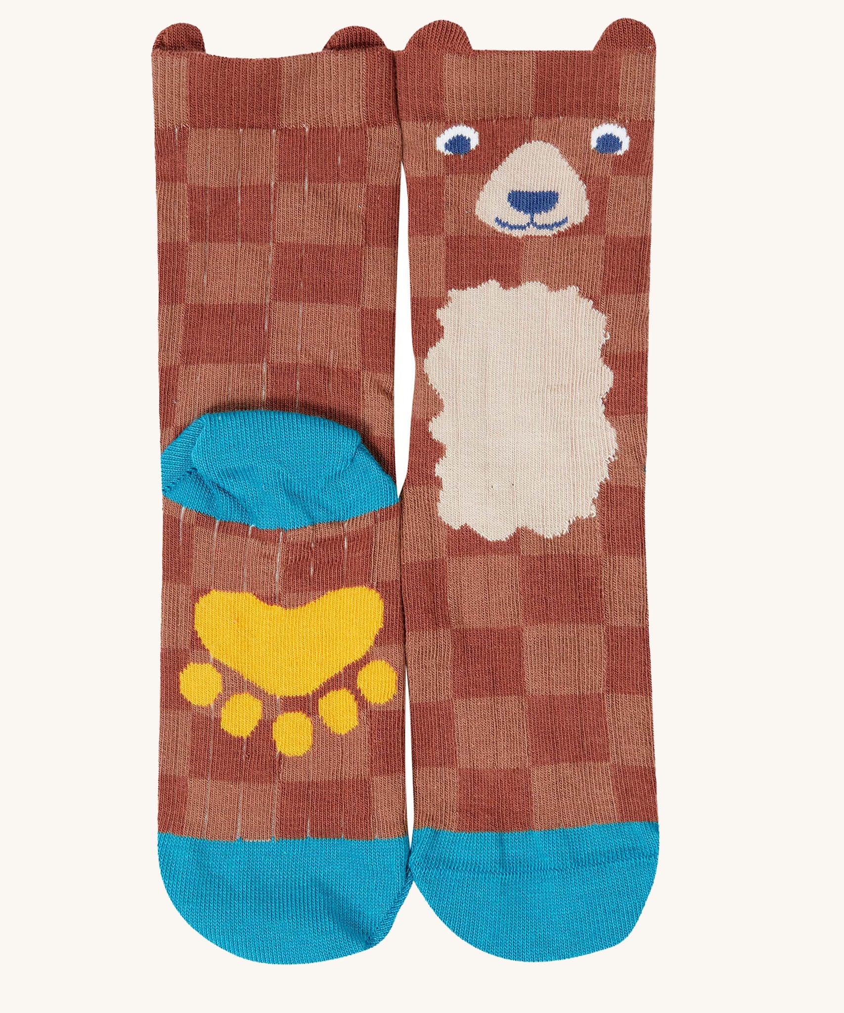 A close up of the Frugi bear character sock from the beary wild pack. A brown GOTS organic cotton sock with blue trim and a yellow paw on the sole.