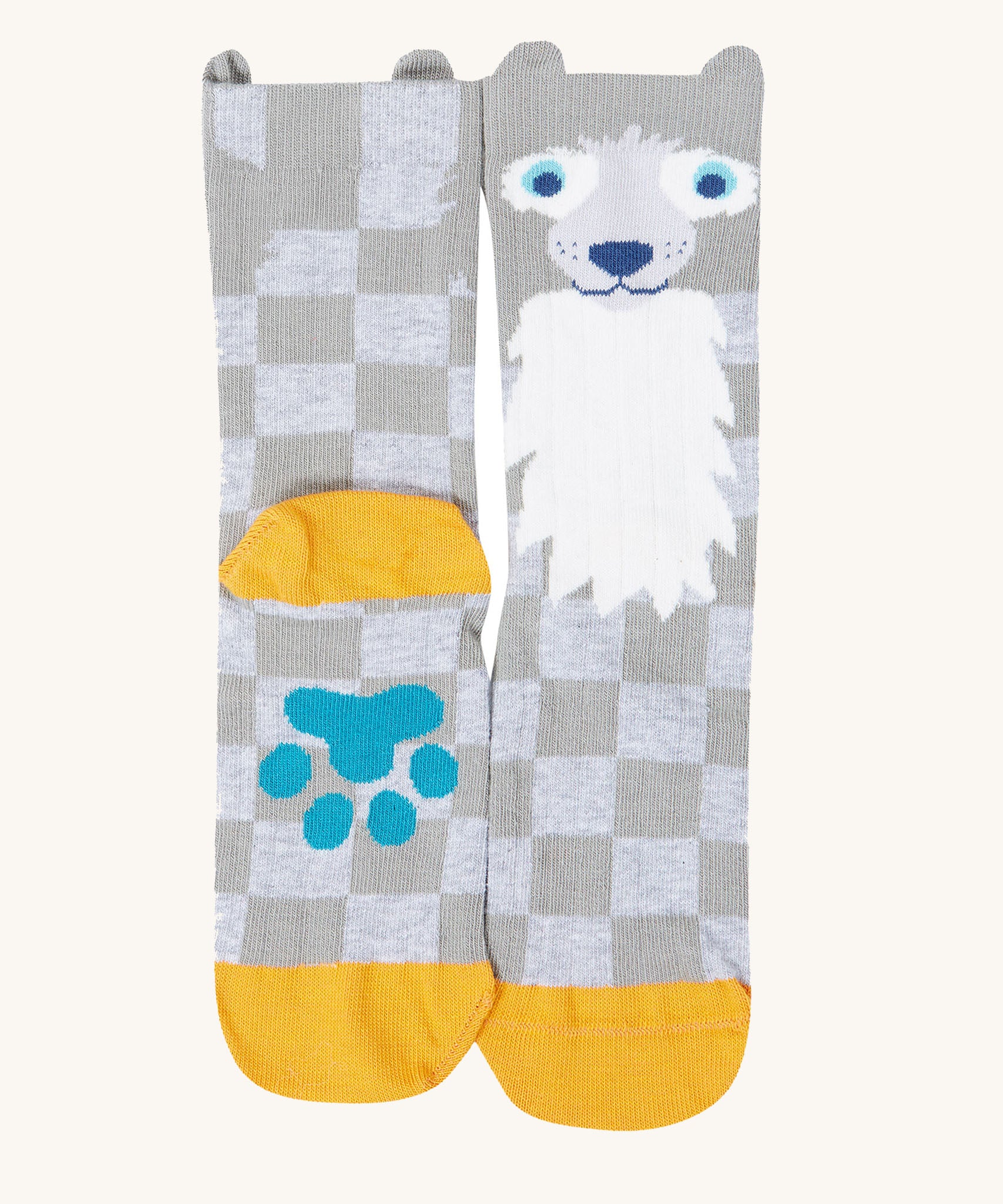 A close up of the Frugi wolf character sock from the beary wild pack. A grey GOTS organic cotton sock with yellow trim and a blue paw on the sole.