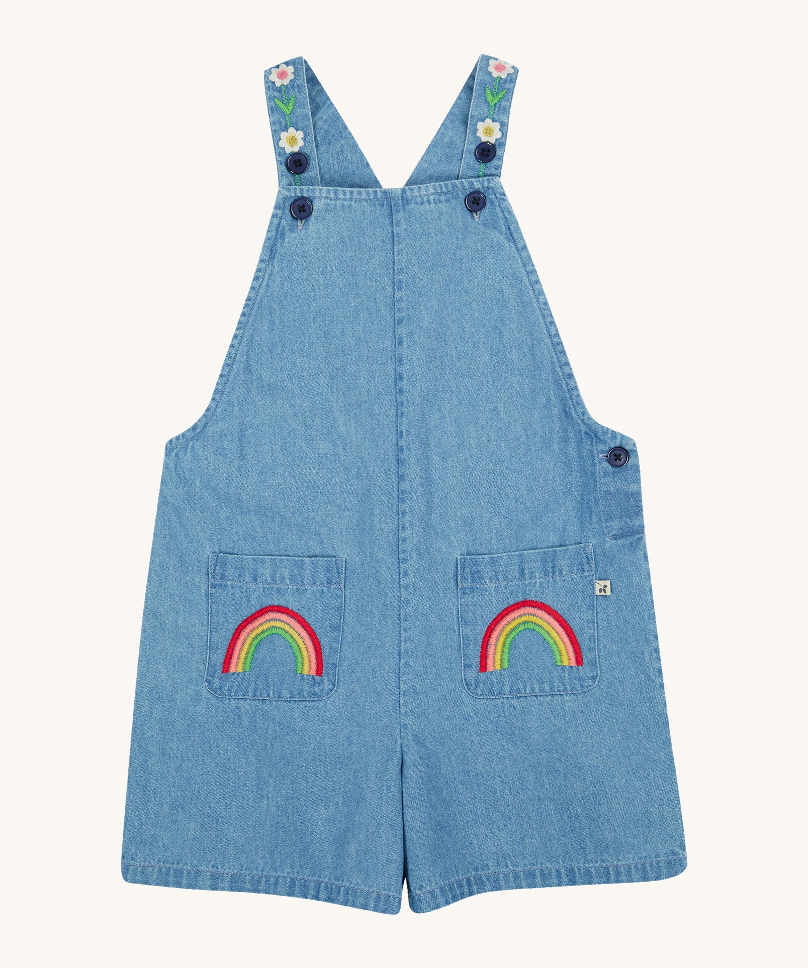 Frugi blue denim short dungarees rainbow design on a cream background.