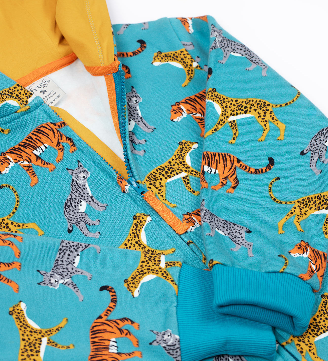A close up of the zip closure on the front of the Frugi Organic Cotton blue wild cats print Children's Big Snuggle Suit. This all in one snuggle suit is a part of a wide range of organic cotton clothing for children available here at Babipur. 