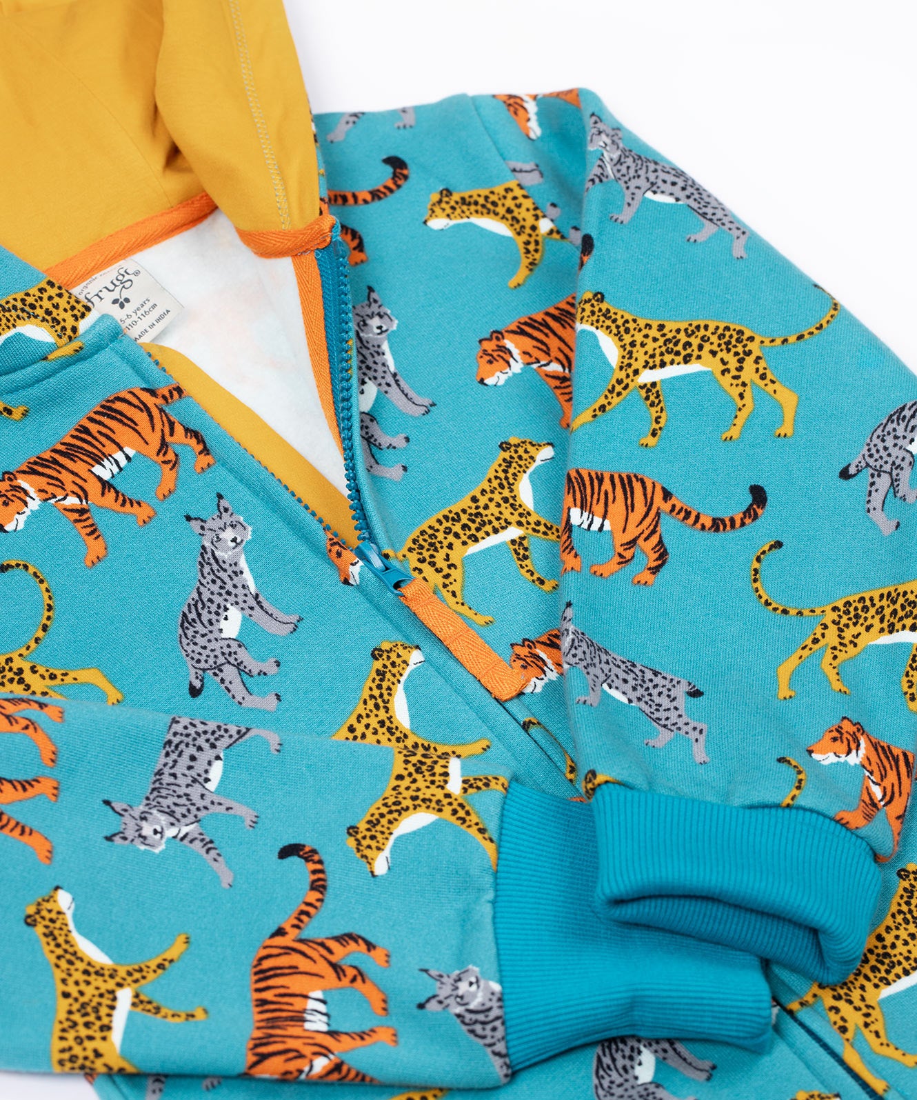A close up of the zip closure on the front of the Frugi Organic Cotton blue wild cats print Children's Big Snuggle Suit. This all in one snuggle suit is a part of a wide range of organic cotton clothing for children available here at Babipur. 