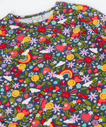 A close up of the Frugi organic cotton long sleeve top laid flat. In navy with a repeating rainbow, flowers, sun and heart print