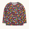 Frugi organic cotton long sleeve top laid flat. In navy with a repeating rainbow, flowers and sun print