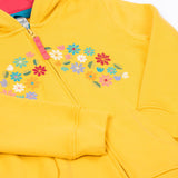 A close up of the Frugi kids carbis hoodie in bumblebee/flowers showing the delicate flower embroidery and pouch pocket detail on yellow organic cotton fabric.