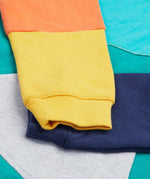 Frugi kids hoodie in a green colour and mulitcoloured block design cuff detail
