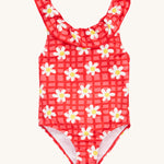 Frugi coral little swimsuit daisy chain design on a cream background.