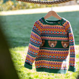 Frugi fowey bear fairisle organic cotton knitted jumper on a hanger hanging on a thick rope