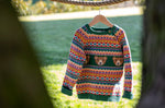 Frugi fowey bear fairisle organic cotton knitted jumper on a hanger hanging on a thick rope