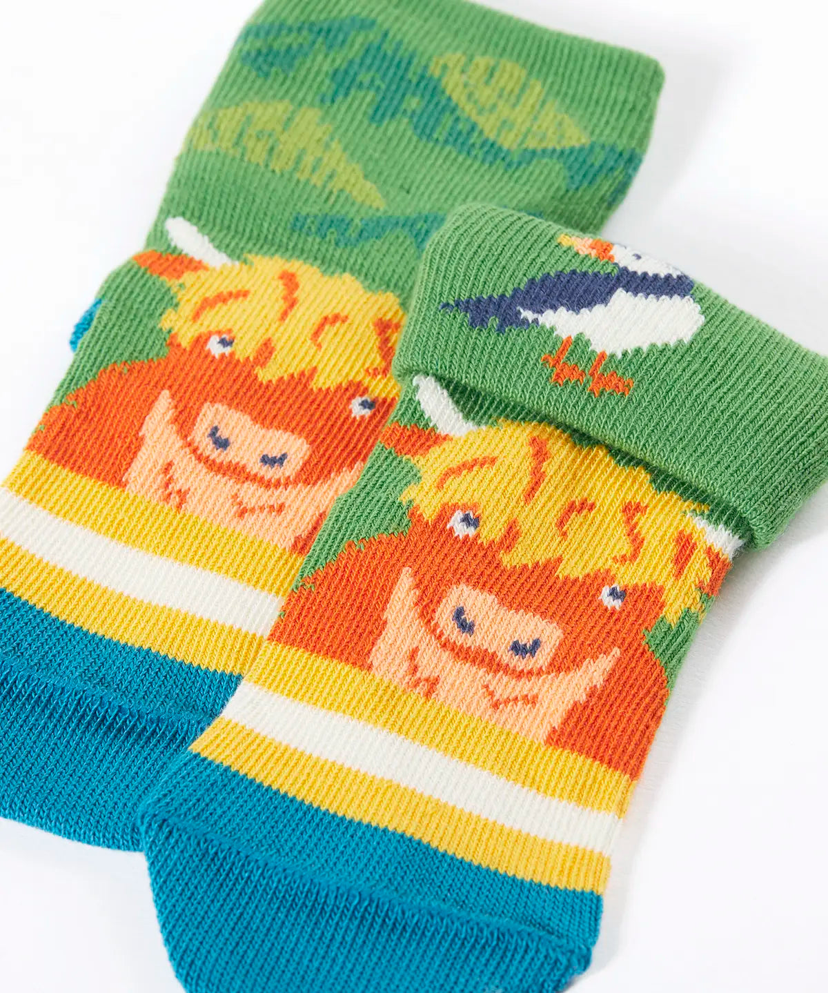 Frugi GOTS organic cotton sock showing one pair with yellow stripes with a little Highland cow and details hidden under the cuff