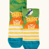 Frugi GOTS organic cotton socks showing a yellow stripes with a little Highland cow with details hidden under the cuff