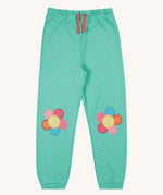 Frugi green crawler joggers daisy design on a cream background.