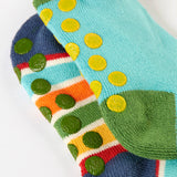A close up of the underside of the Frugi organic cotton 2 pack socks laid flat. In blue and striped colours with little circle grip panels