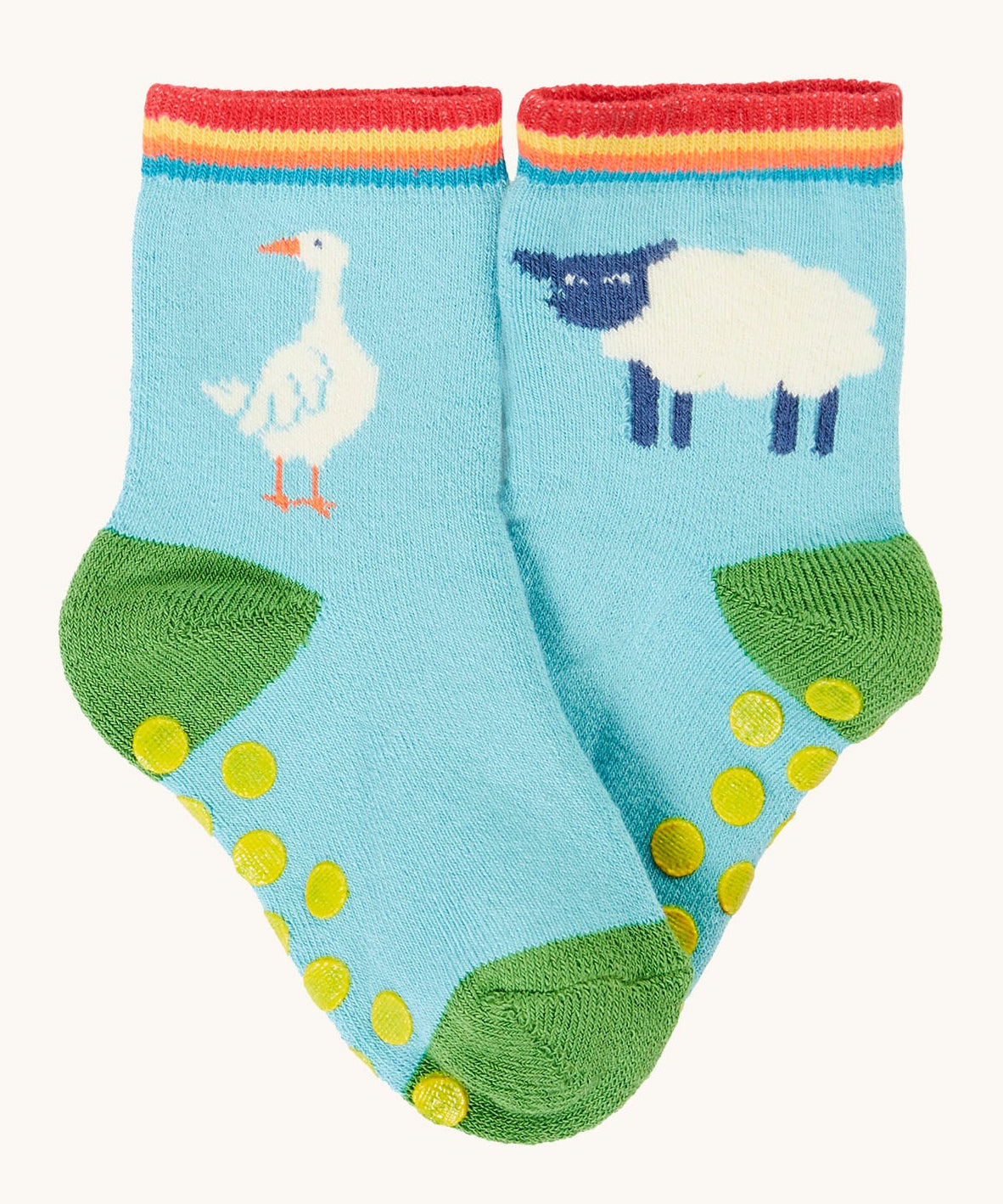 Frugi organic sock laid flat. In light blue with a white goose on one sock and a white sheep on the other.