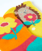 A close up of the Frugi organic cotton 2 pack socks laid flat. In bright striped hedgehog themed colours and designs