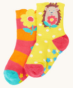 Frugi organic cotton 2 pack socks laid flat. In a floral and hedgehog themed colours and designs 