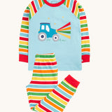 Frugi organic cotton pyjama set laid flat. A light blue top with striped sleeves and a tractor design on the front and matching striped trousers