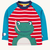 Frugi kids alfie raglan top in berry red/ breton frog available at Babipur. A GOTS organic cotton top with blue long sleeve and red/white stripes. Features a playful green frog applique on the front and popper fasteners on the shoulder.