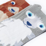 A close up of the Frugi kids beary wild character socks 2 pack showing the face detail on the bear and wolf sock on organic cotton fabric