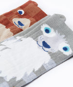 A close up of the Frugi kids beary wild character socks 2 pack showing the face detail on the bear and wolf sock on organic cotton fabric
