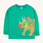 Frugi kids green stop in a green colour with a triceratops design on a cream bakground.