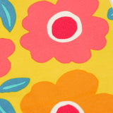 A close up of the repeating floral print on the yellow Frugi leggings