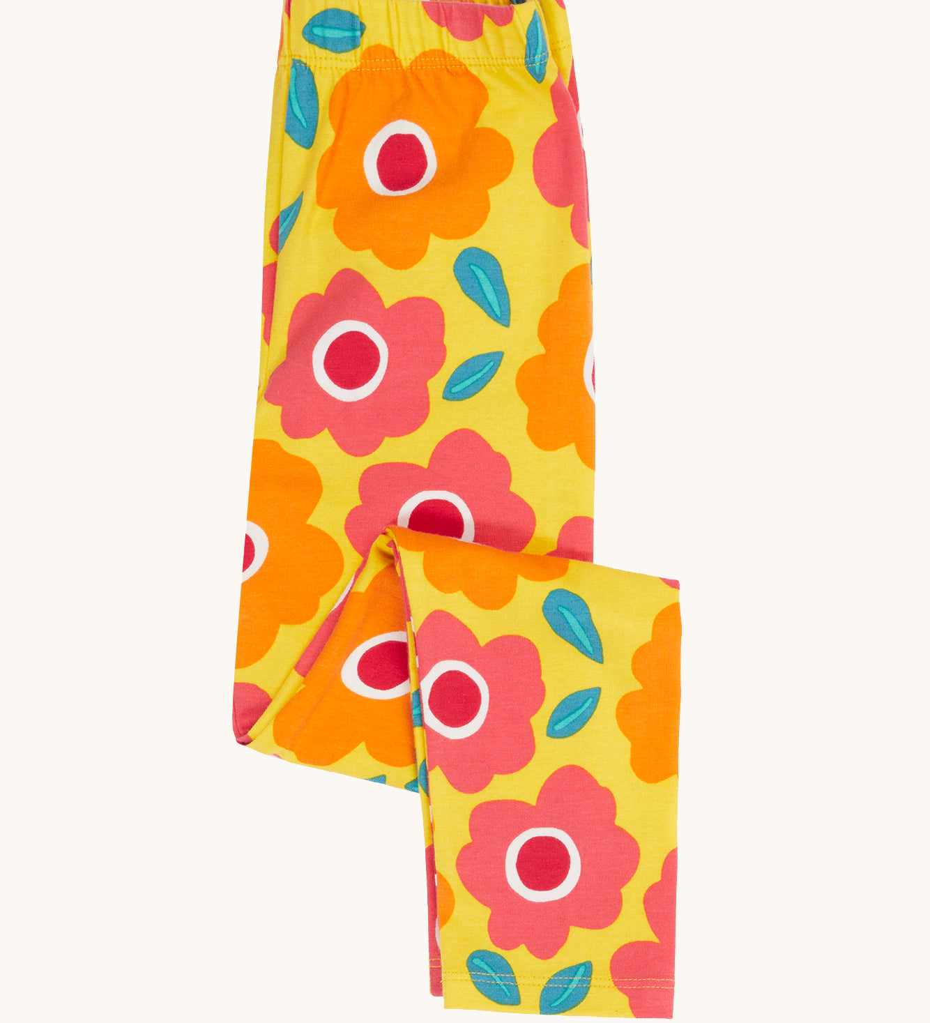 Frugi organic cotton leggings folded and laid flat. In bright yellow with a repeating floral print