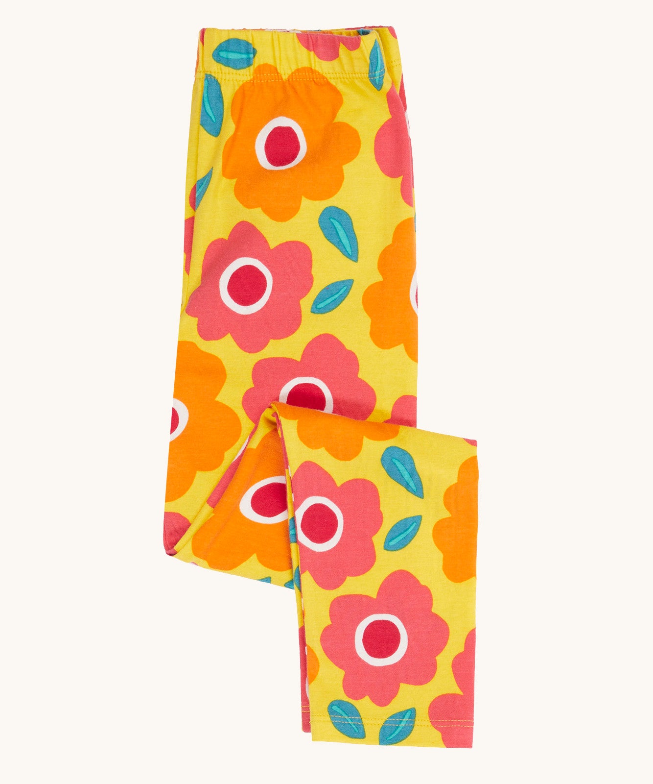 Frugi organic cotton leggings folded and laid flat. In bright yellow with a repeating floral print