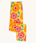 Frugi organic cotton leggings folded and laid flat. In bright yellow with a repeating floral print
