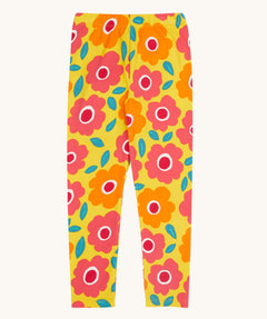 Frugi organic cotton leggings laid flat. In bright yellow with a repeating floral print