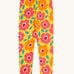 Frugi organic cotton leggings laid flat. In bright yellow with a repeating floral print