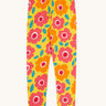 Frugi organic cotton leggings laid flat. In bright yellow with a repeating floral print