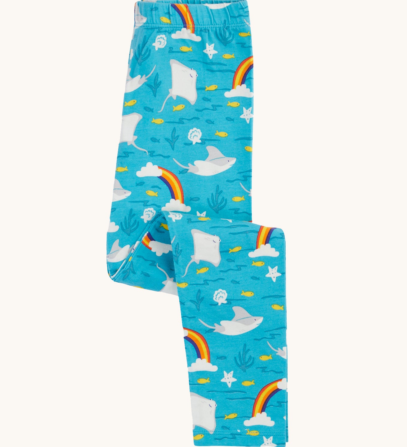 Frugi organic cotton leggings folded and laid flat. In bright blue with a repeating grey manta ray and rainbow print