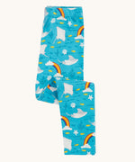 Frugi organic cotton leggings folded and laid flat. In bright blue with a repeating grey manta ray and rainbow print