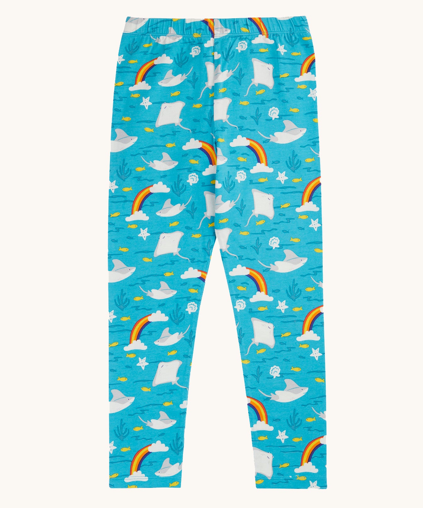 Frugi organic cotton leggings laid flat. In light blue with a repeating grey manta ray and rainbow print.