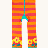The back of the frugi knitted leggings. In orange and pink stripe with yellow flowers on each leg