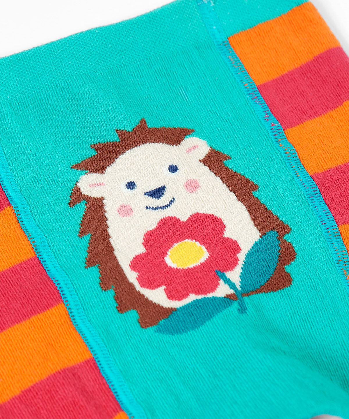 A close up of the hedgehog design on the front of the Frugi knitted leggings.