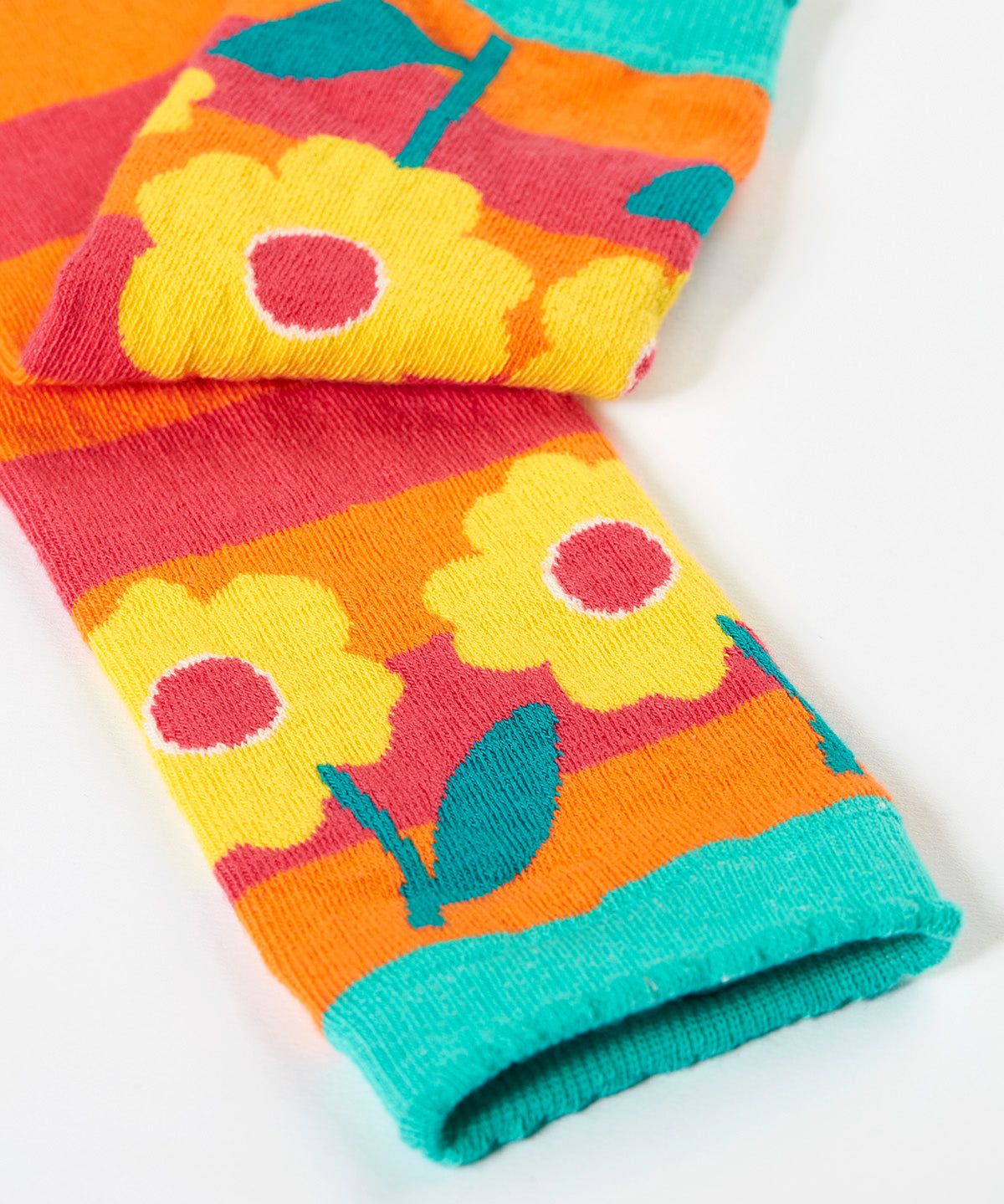 A close up of the yellow flower  design on one leg of the Frugi knitted leggings.